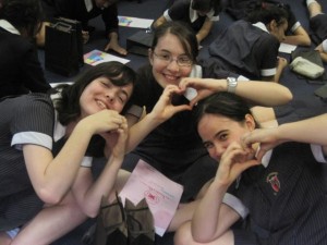 girls making heart signs